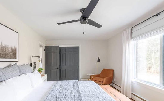 Cassius Outdoor Ceiling Fan in matte grey finish mounted in neutral bedroom on a white ceiling.