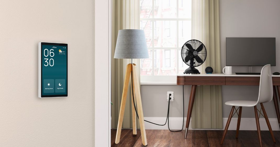 HunterSMART™ Wall Panel mounted beside a home office, featuring a touchscreen for connected control of smart home devices.
