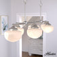 19492_1_saddle_creek_shiny_cased_white_glass_7_light_linear_chandelier-brushed_nickel-lifestyleimages1c