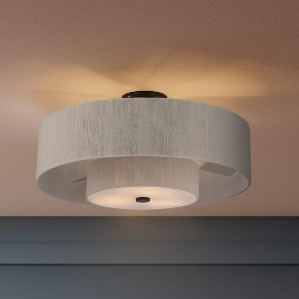 Modern bedroom with blue accent wall, and flush mount ceiling light.