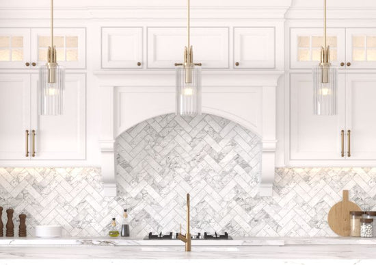 Modern kitchen island featuring Gatz pendants in a gold finish.