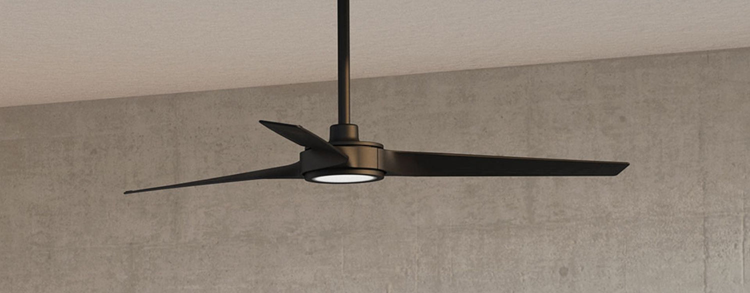Minimalist three-blade ceiling fan in a matte black finish with a low-profile integrated light, set against a textured neutral ceiling.
